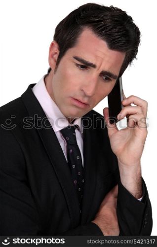 businessman on the phone looking concerned