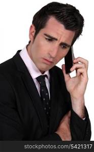businessman on the phone looking concerned