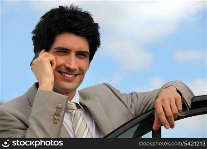 Businessman on the phone outdoors