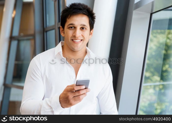 Businessman on the phone sitting at the computer in his office. Being connected and in touch