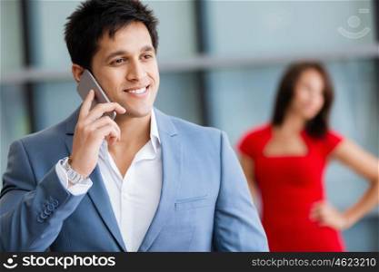 Businessman on the phone standing in his office. Being connected and in touch