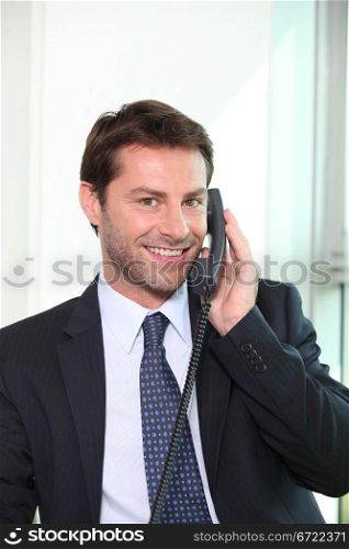 Businessman on the telephone smiling