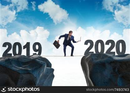 Businessman on the tight rope from year 2019 to 2020. Businessman on tight rope from year 2019 to 2020