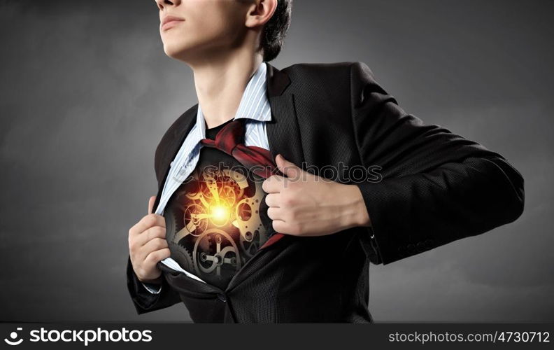 Businessman opening his shirt on chest acting like super hero. Super professional