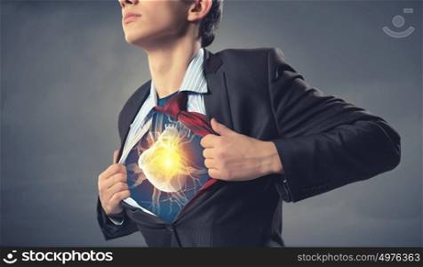Businessman opening his shirt on chest acting like super hero. Super professional