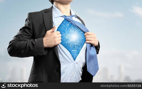 Businessman opening his shirt on chest acting like super hero. Super professional