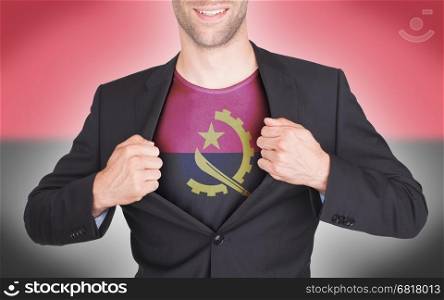 Businessman opening suit to reveal shirt with flag, Angola