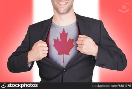 Businessman opening suit to reveal shirt with flag, Canada