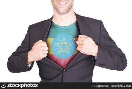 Businessman opening suit to reveal shirt with flag, Ethiopia