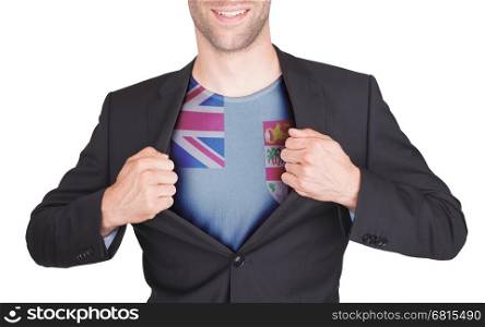 Businessman opening suit to reveal shirt with flag, Fiji
