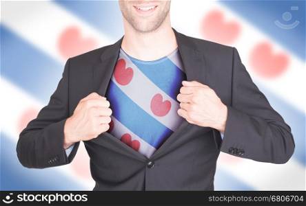 Businessman opening suit to reveal shirt with flag, Friesland