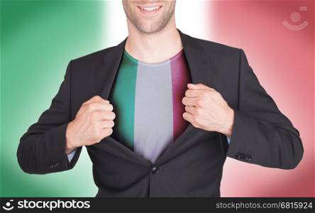 Businessman opening suit to reveal shirt with flag, Italy