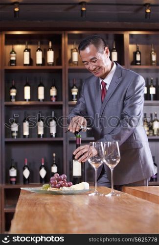 Businessman Opening Wine Bottle
