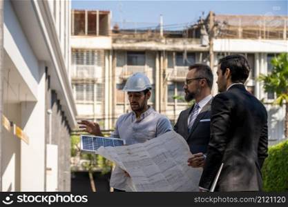 businessman or owner meeting building consults engineering team design of the building solar cell system or energy engineer plan project under construction. clean and green alternative energy concept.