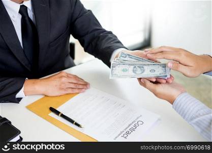 Businessman or politician taking bribe and Shaking Hands With Money in a suit, corruption trade exchange concept