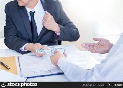 Businessman or politician taking bribe and Shaking Hands With Money in a suit, corruption trade exchange concept