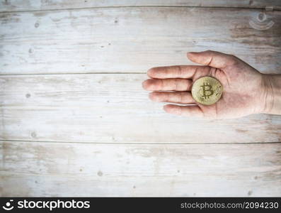 Businessman or woman holding bitcoin.Golden bitcoin coins in human hands. Virtual currency. Crypto currency. New virtual money. Opened wallet. copy space top view space for text. Businessman or woman holding bitcoin.Golden bitcoin coins in human hands. Virtual currency. Crypto currency. New virtual money. Opened wallet. copy space top view