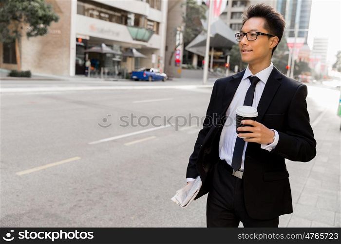 Businessman outdoors in city business district. Busy day and busy life