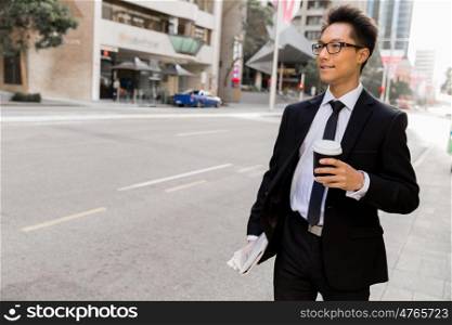 Businessman outdoors in city business district. Busy day and busy life