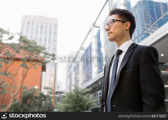 Businessman outdoors in city business district. I am professional and know it