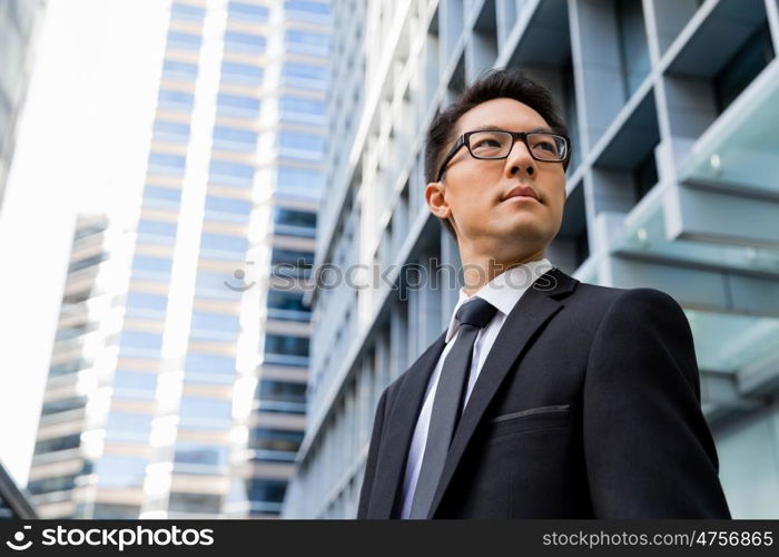 Businessman outdoors in city business district. I am professional and know it