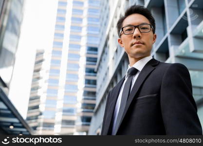 Businessman outdoors in city business district. I am professional and know it