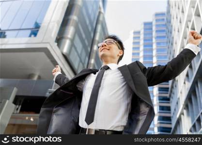 Businessman outdoors in city business district. I know we will succeed