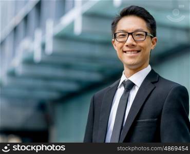 Businessman outdoors in city business district. I know we will succeed
