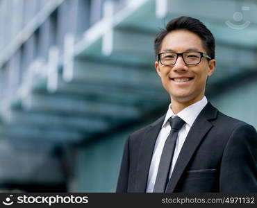 Businessman outdoors in city business district. I know we will succeed