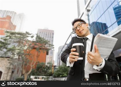 Businessman outdoors in city business district. No minute wasted