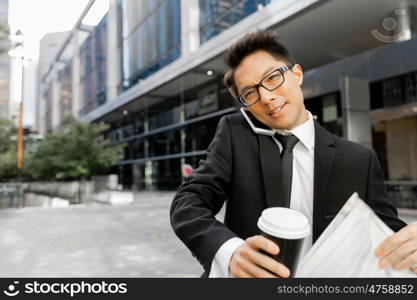 Businessman outdoors in city business district. No minute wasted