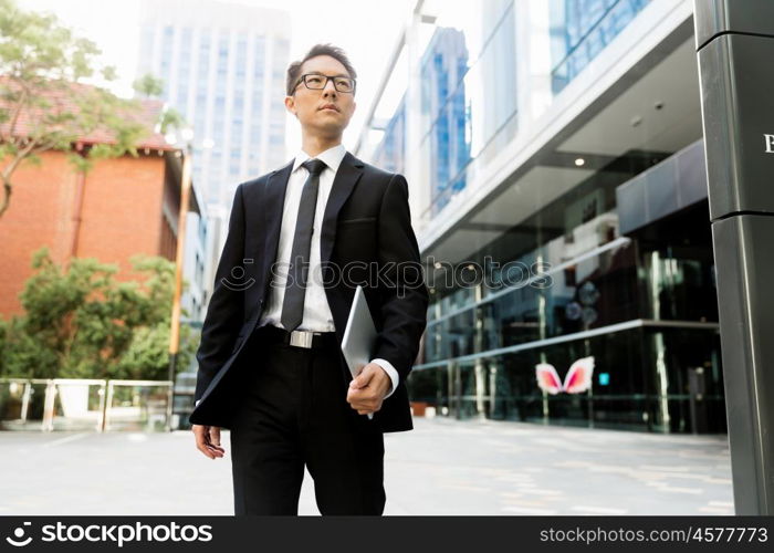 Businessman outdoors in city business district. On my way to success