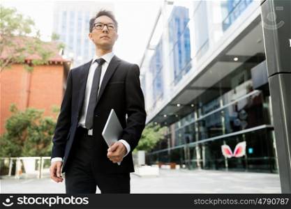 Businessman outdoors in city business district. On my way to success
