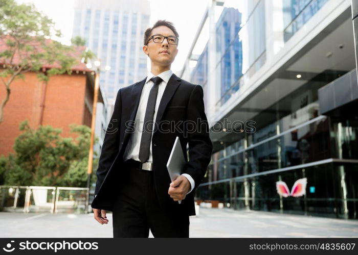 Businessman outdoors in city business district. On my way to success