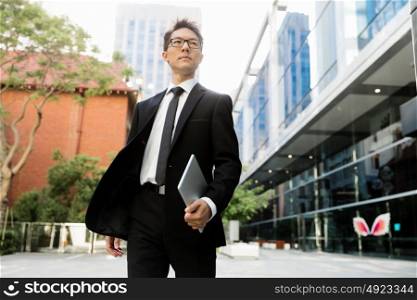 Businessman outdoors in city business district. On my way to success