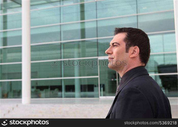 Businessman outside a glass fronted building