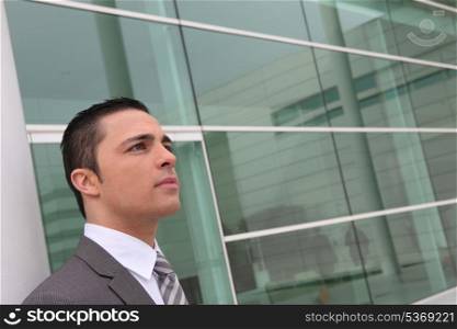 Businessman outside a glass-fronted building