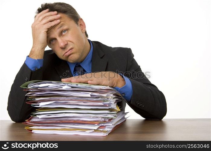 Businessman Overwhelmed By Paperwork