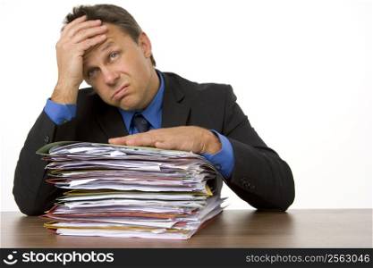 Businessman Overwhelmed By Paperwork