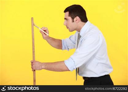 Businessman painting plank of wood