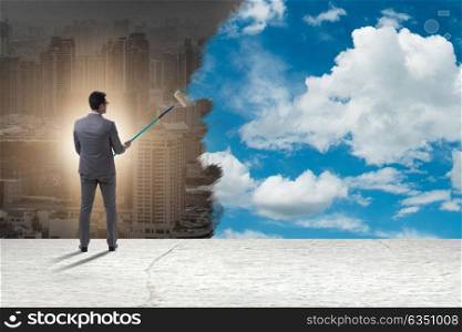 Businessman painting sky and clouds