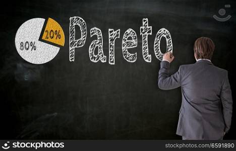 Businessman paints Pareto on blackboard concept.. Businessman paints Pareto on blackboard concept