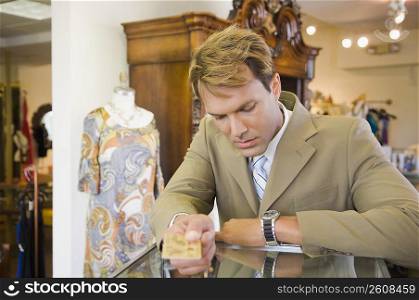 Businessman paying with a credit card in a clothing store