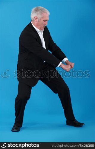 Businessman performing pull gesture