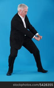 Businessman performing pull gesture