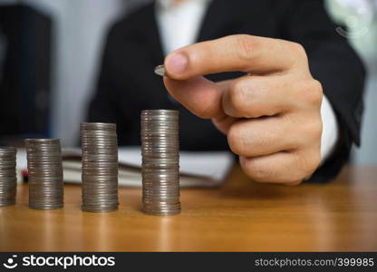 Businessman picks coins on the table, counts money . Business concept.