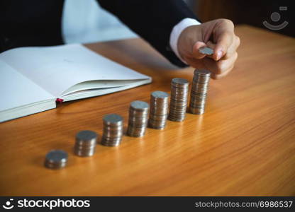 Businessman picks coins on the table, counts money . Business concept.