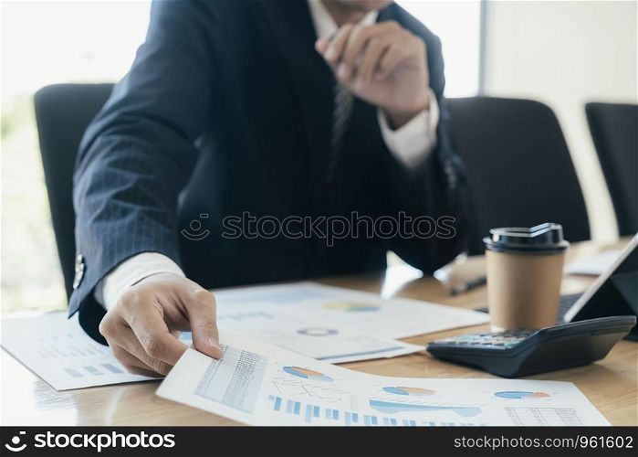 Businessman planning and analyse investment marketing data.