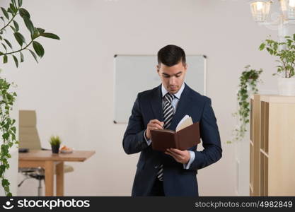 Businessman planning and taking notes at his office