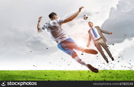 Businessman play ball. Young businessman in suit playing football with players outdoors